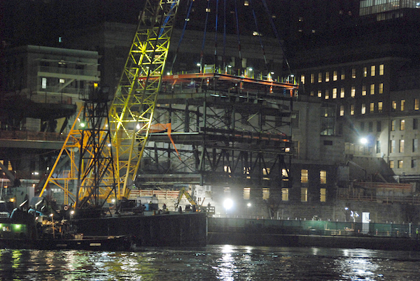 A close-up of the module being put in place, with the FDR Drive at the level where there is green fencing. | FRANK FARANCE 