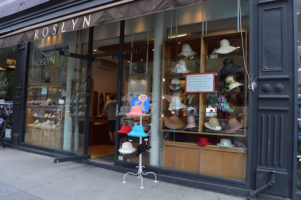 With vibrant store windows and hats arrayed outdoors, Roslyn draws customers in. | JACKSON CHEN 