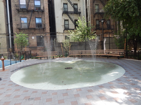 Renovations Revitalize Ramon Aponte Park 4 Newly-installed sprinklers in the playground provide relief from the heat. Photo by Jane Argodale.