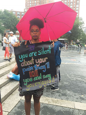 Black Lives Matter Protesters March Throughout the Weekend 1 Indigo Goodson of Brooklyn carried a sign at a July 8 rally in Union Square. Photo by Lauren Vespoli.