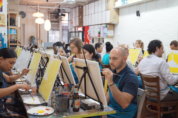Attendees to Painting Lounge's class work on their skyline painting. Photo by Nicole Javorsky.