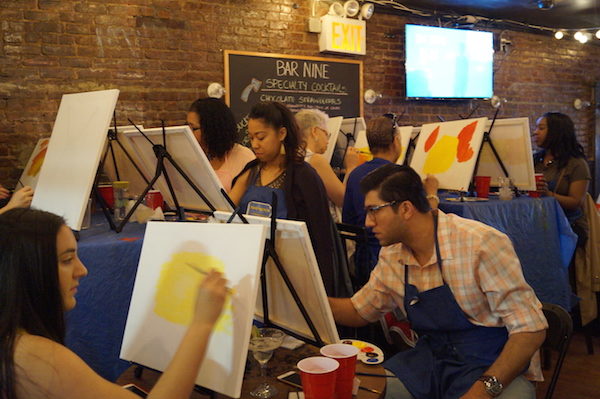 Individuals at Bar Nine start their painting of a sunset with the help of Painting Circle instructor Irina Fialko. Photo by Nicole Javorsky.