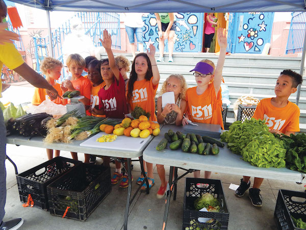 Farmers Market Produce Makes for Delicious Meals 1 Third graders at the PS 11 Farm Market clamor to answer a customer’s question. Photo by Jane Argodale.