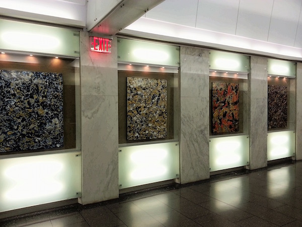 The eight abstract acrylic paintings that comprise “Hardship of Hope” are on permanent display in the lobby of 65 Broadway. Courtesy the artist.