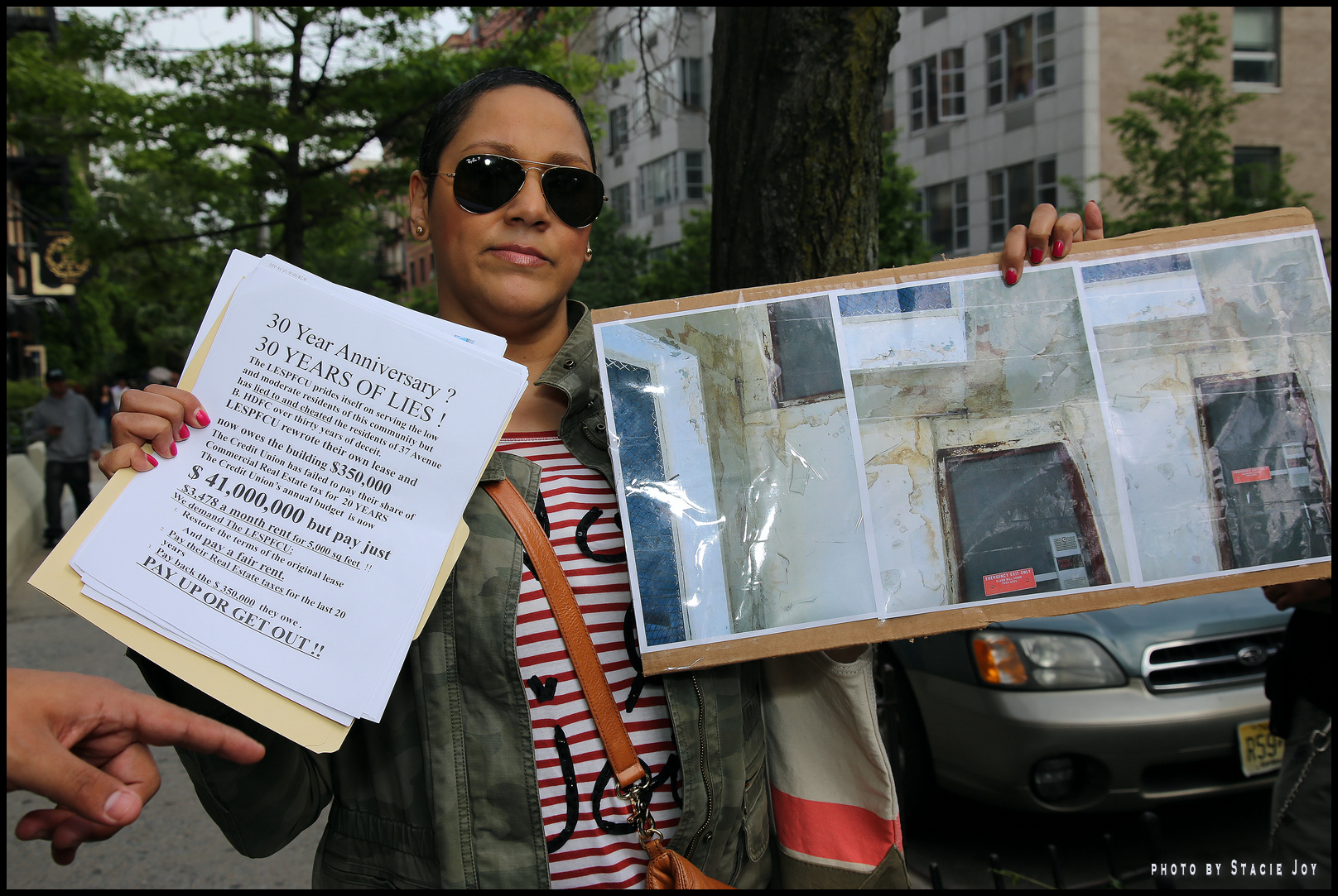 A tenant showed a photo of dilapidated conditions inside the building. The credit union says some of the  figures in the tenants' protest fliers are way off, however.