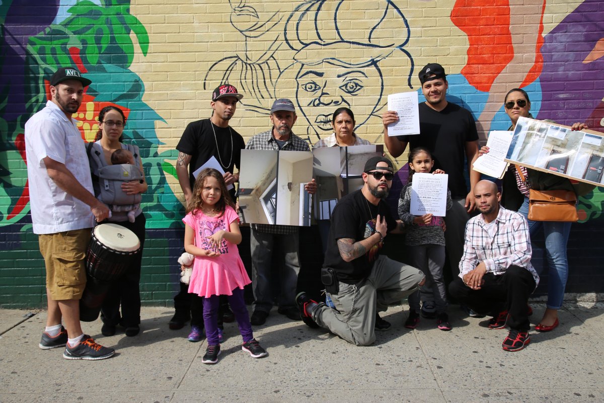 Tenants of 37 Avenue B Ñ some holding photos of decrepit conditions inside the building Ñ protested in May as the L.E.S. PeopleÕs Federal Credit Union was throwing its 30th anniversary celebration.