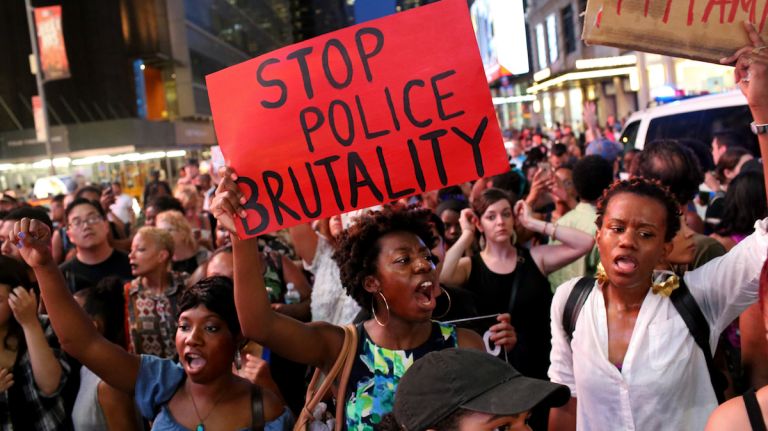Shouts and signs do the talking as demonstrators march through Manhattan on July 7, 2016, to protest the deaths of two black men at the hands of police in Louisiana and Minnesota. 