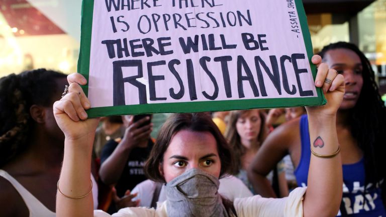 A demonstrator's sign states her cause during a march through Manhattan on July 7, 2016, to protest the deaths of two black men at the hands of police in Louisiana and Minnesota. 