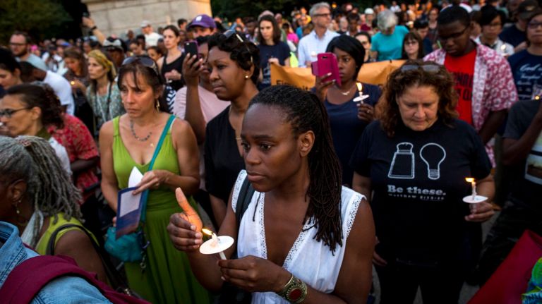 Yvonne Thomas of Brooklyn, center, listens to a speaker during a vigil at Grand Army Plaza in Brooklyn on July 11, 2016, held in light of recent violence across the nation.