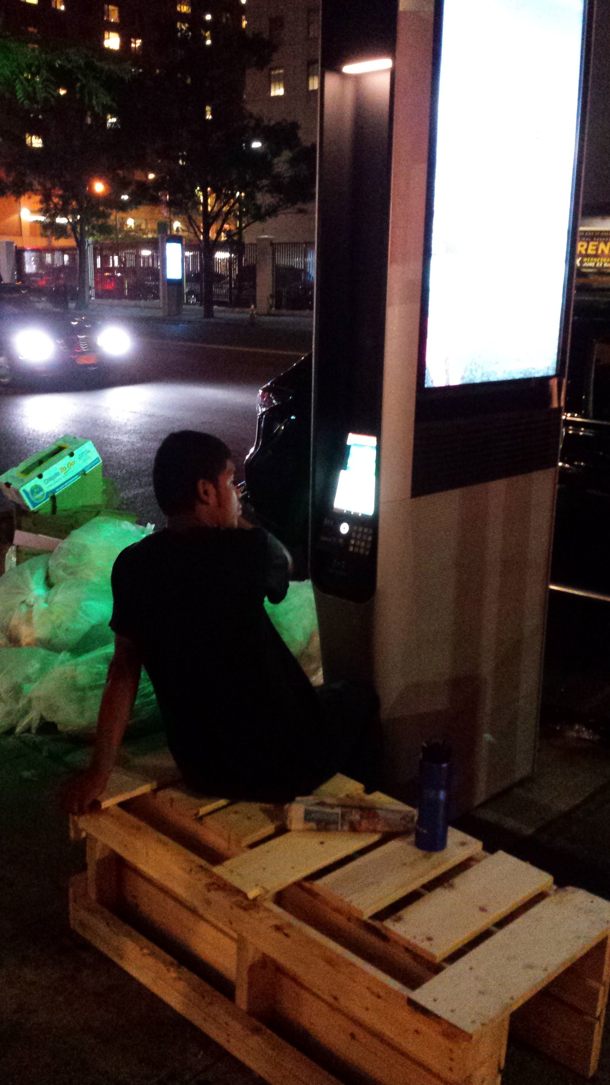 This guy wasn't watching porn on this sidewalk WiFi kiosk on Third Ave. earlier this year. He would watch cartoons. But he was sitting there for hours. Councilmember Corey Johnson opposes restoring Web browsing capability to the kiosks because he foresees they will become sidewalk "Internet cafes." Photo by Scoopy