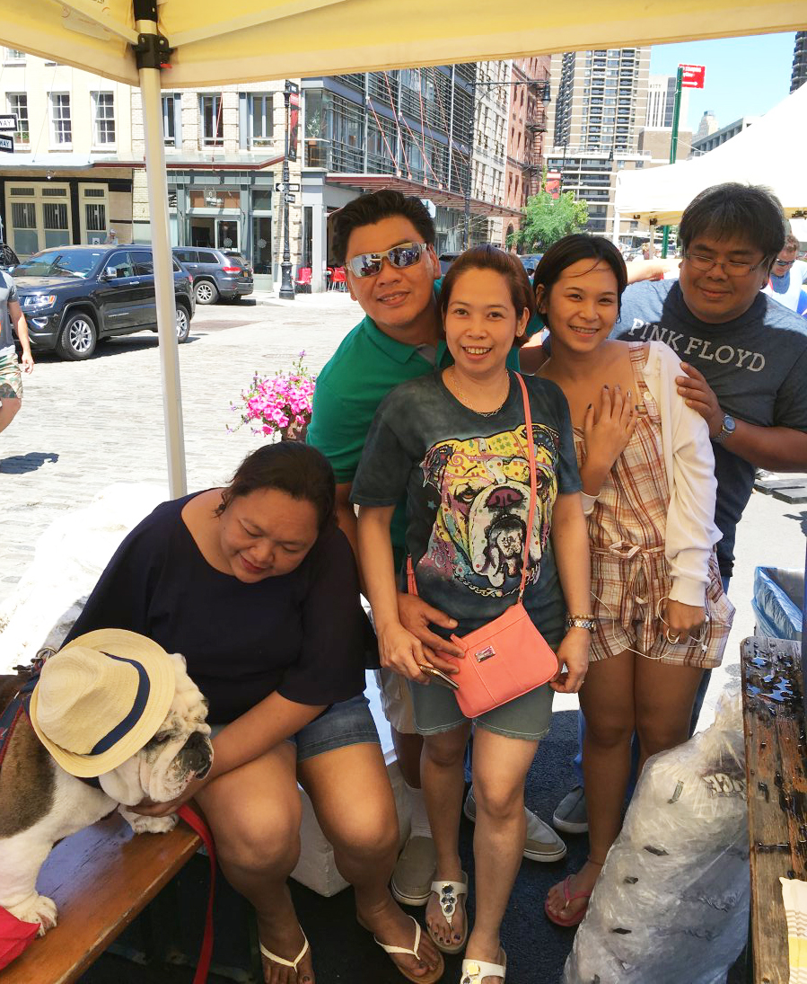 Photo by Janel Bladow This family came all the way from the Philippines to the “Strut, Swagger and Slobber Bully Beach Party” to meet host James Goubeaux’s bulldog Oliver.