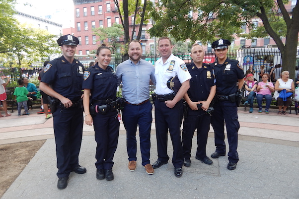 City Councilmember Corey Johnson (just left of center) with Inspector Peter Venice (to right of Johnson), the Midtown North precinct commanding officer, and other precinct officers at Hell’s Kitchen Park on August 2. | JANE ARGODALE 