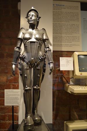A ¼ scale replica statue of Futura, from the 1927 motion picture “Metropolis” alongside a 1984 Apple llc. Both are up for bid as Tekserve closes its Chelsea retail store. Photo by Alex Ellefson.