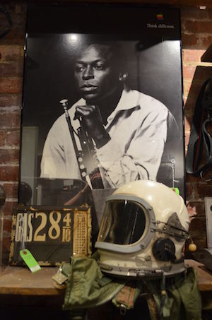 A high-altitude helmet used by MiG fighter pilots in the 1970s and a poster of Miles Davis from Apple's “Think Different” ad campaign are yours to take home, if the price is right. Photo by Alex Ellefson