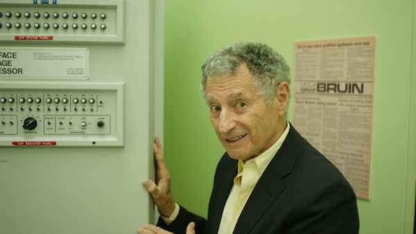 Dr. Leonard Kleinrock shows off the machine that sent the first message via the Internet at UCLA in the prelude to “Lo and Behold.” Courtesy Magnolia Pictures.