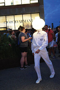 A man dressed to impress, or at least make an impression, walks past the stargazing crowd. Photo by Nicole Javorsky.