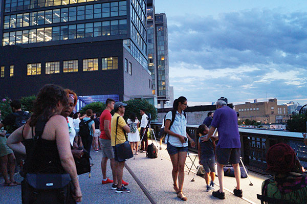 Visitors to the High Line gather around the telescopes set up by the Amateur Astronomers Association. Photo by Nicole Javorsky.