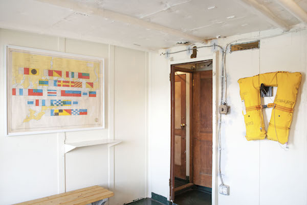 In the main gallery space, Adam Payne’s drawing “Hi Ho The Derry O The Cheese Stands Alone” and the life jacket “To Help Give Up The Ship.” Photo by Sam Monaco.