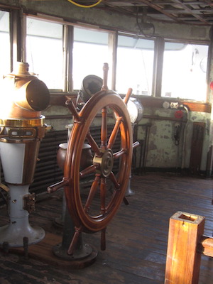 The ship never sails on Lilac’s living history 5 Wheel fun: Visitors to the bridge can take the steering mechanism for a spin. Photo by Mary Habstritt.
