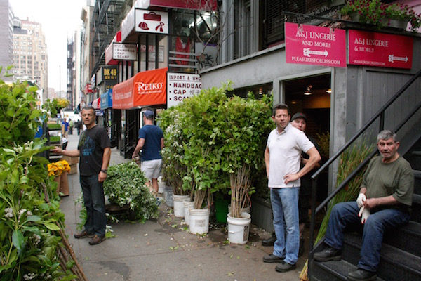 Louie Theofanis, second from right, in front of Major Wholesale Florist (41 W. 28th St.), which he runs with his brother-in-law Saki Tornesakis, left. Photo by Yannic Rack.