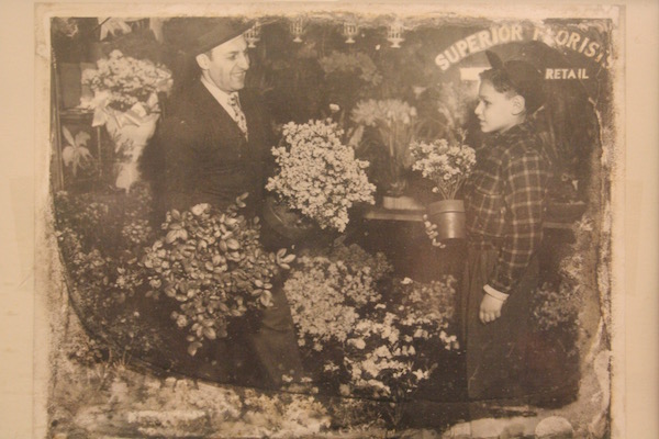 A nine-year-old Sam Rosenberg with his father inside Superior Florist. Rosenberg, now 78, still runs the outfit together with his son and grandson, who will likely take over the shop one day. Photo courtesy the Rosenburg family.