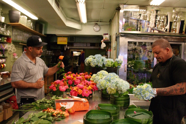 Carlos Santos, left, and Jesus Rivera prepare orders and arrangements at Superior Florist for the next day. Photo by Yannic Rack.