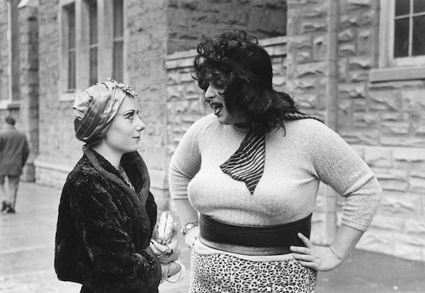 A connection forged by beads: Mink Stole (left), as Mink, and Divine, as Lady Divine. Photo by Lawrence Irvine.