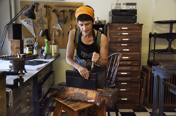 Judith Ivry working in her studio on E. Fourth St. Photo by Bob Krasner.