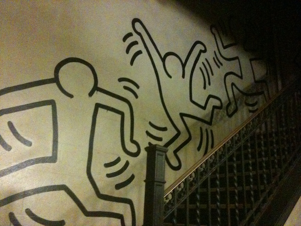 Can This Haring Be Saved? 1 USE CHEN haring ryanishungry at flickr.jpg A portion of the Keith Haring mural that winds its way up a stairwell at 218 West 108th Street. | COURTESY: RYANISHUNGRY/ FLICKR.COM
