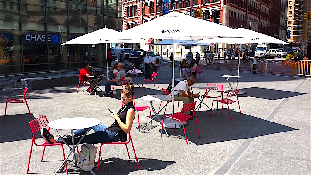Enjoying a beautiful day in the new Astor Place plaza, which now sports tables and umbrellas, courtesy of the Village Alliance BID.