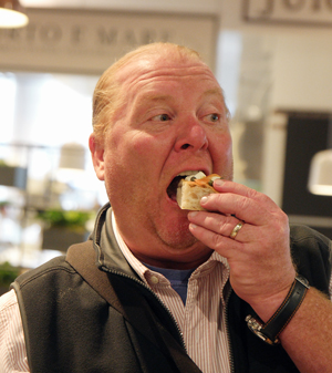 Photo by Milo Hess Celebrity chef and Eataly partner Mario Batali couldn't resist snarfing down a snack at the high-end food mall's preview event on Aug. 2.