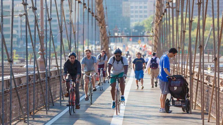 People cycling and walking on Brooklyn Bridge