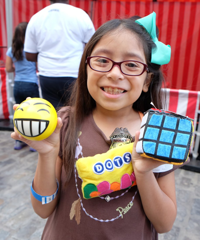 Photo by Tequila Minsky Little Ahulani Gonzalez left the First Precinct's National Night Out event with lots of prizes.