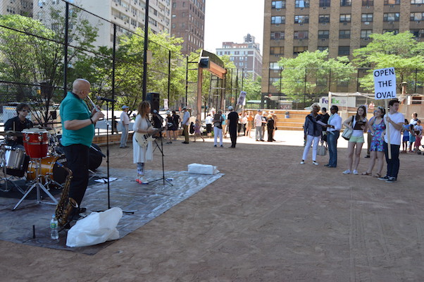Neighborhood residents gathered for a June rally demanding that Queensboro Oval be returned to full time public use when the current tennis club lease expires next August. | JACKSON CHEN 