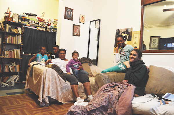 Sandra Johnson and her children and grandchildren at home in their East Harlem apartment. | JACKSON CHEN 