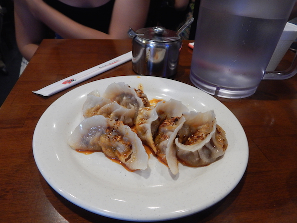 Dumpling Daredevils of Hell’s Kitchen 4 Dumplings, given a generous helping of chili oil at Tasty Hand-Pulled Noodles II. Photo by Sean Egan.