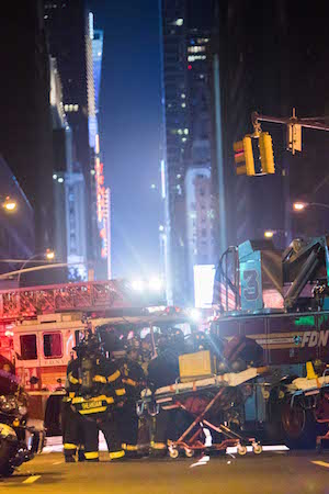 After ‘Craven’ Bombing, Anger and Resolve in Chelsea 2 FDNY personnel with a stretcher and response gear at the ready. 29 people were injured as a result of Saturday night’s explosion. Photo by Daniel Kwak.