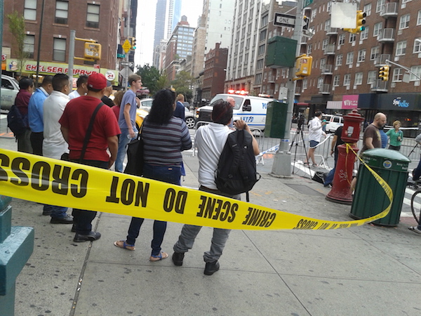 Onlookers at the corner of Seventh Ave. & W. 23rd St. on the morning of Sun., Sept. 18 — as close as they could get to the block btw. Sixth & Seventh Aves., where an explosion occurred the previous night. Photo by Scott Stiffler.