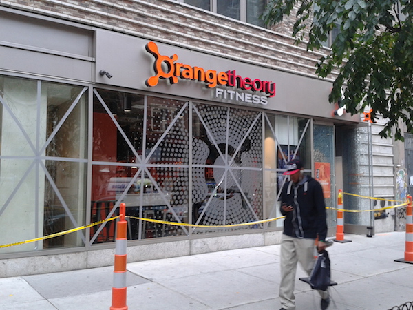Orangetheory Fitness, across from the site of Saturday’s explosion, with windows taped to prevent shattering. Photo by Scott Stiffler.