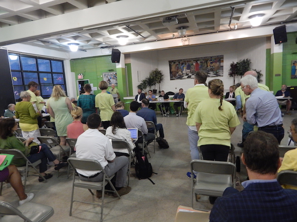 LPC Ruling Latest Clash in Effort to Preserve Chelsea’s Character 2 At Sept. 7’s CB4 meeting, opponents to the 334 W. 20th St. project showed off their numbers by standing strong in neon green T-shirts. Photo by Sean Egan.