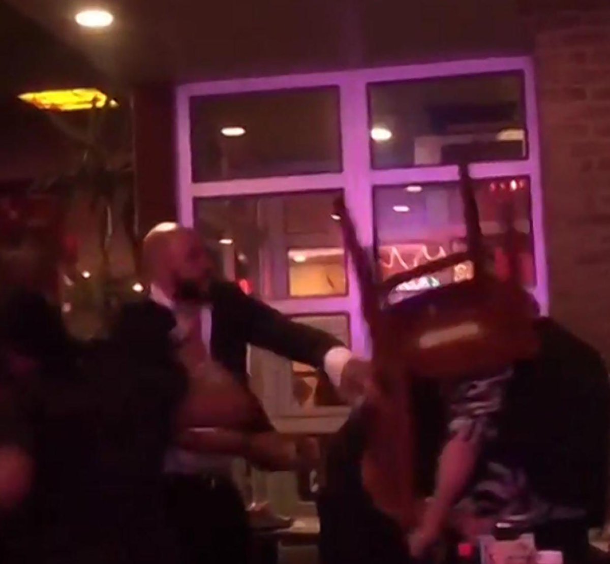 A screen grab from the May 2015 attack at the Chelsea Dallas BBQ, showing El-Amin bashing the two victims over the heads with a wooden chair.