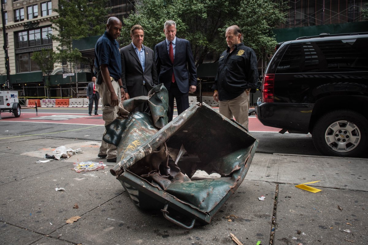 On Sunday morning, Governor Andrew Cuomo and Mayor Bill de Blasio examined the dumpster inside which the bomb exploded on W. 23rd St. the night before.