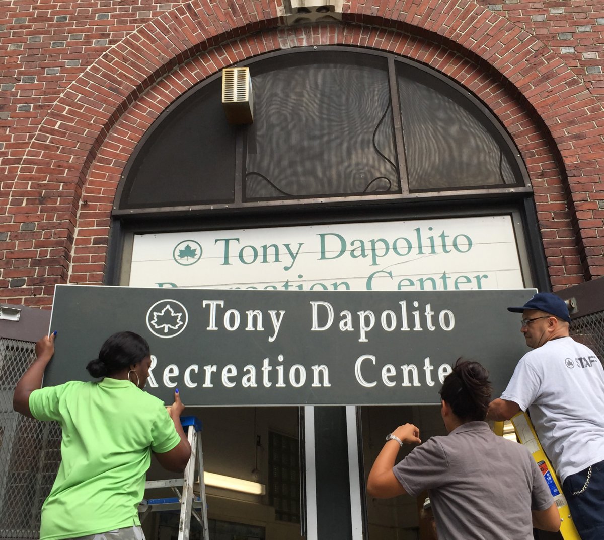 The new sign goes up!