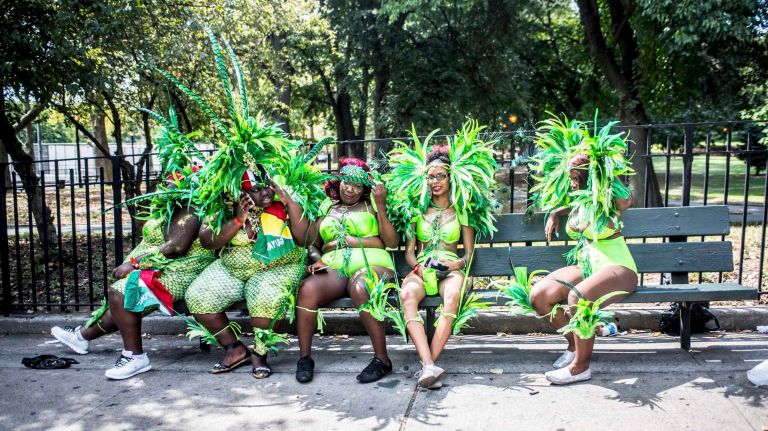 Costumed dancers get ready to march in the West Indian Day Parade along Eastern Parkway in Brooklyn on Monday, Sept. 5, 2016.