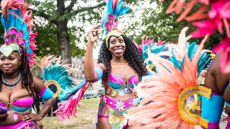 Costumed dancers get ready to march in the West Indian Day Parade along Eastern Parkway in Brooklyn on Monday, Sept. 5, 2016.