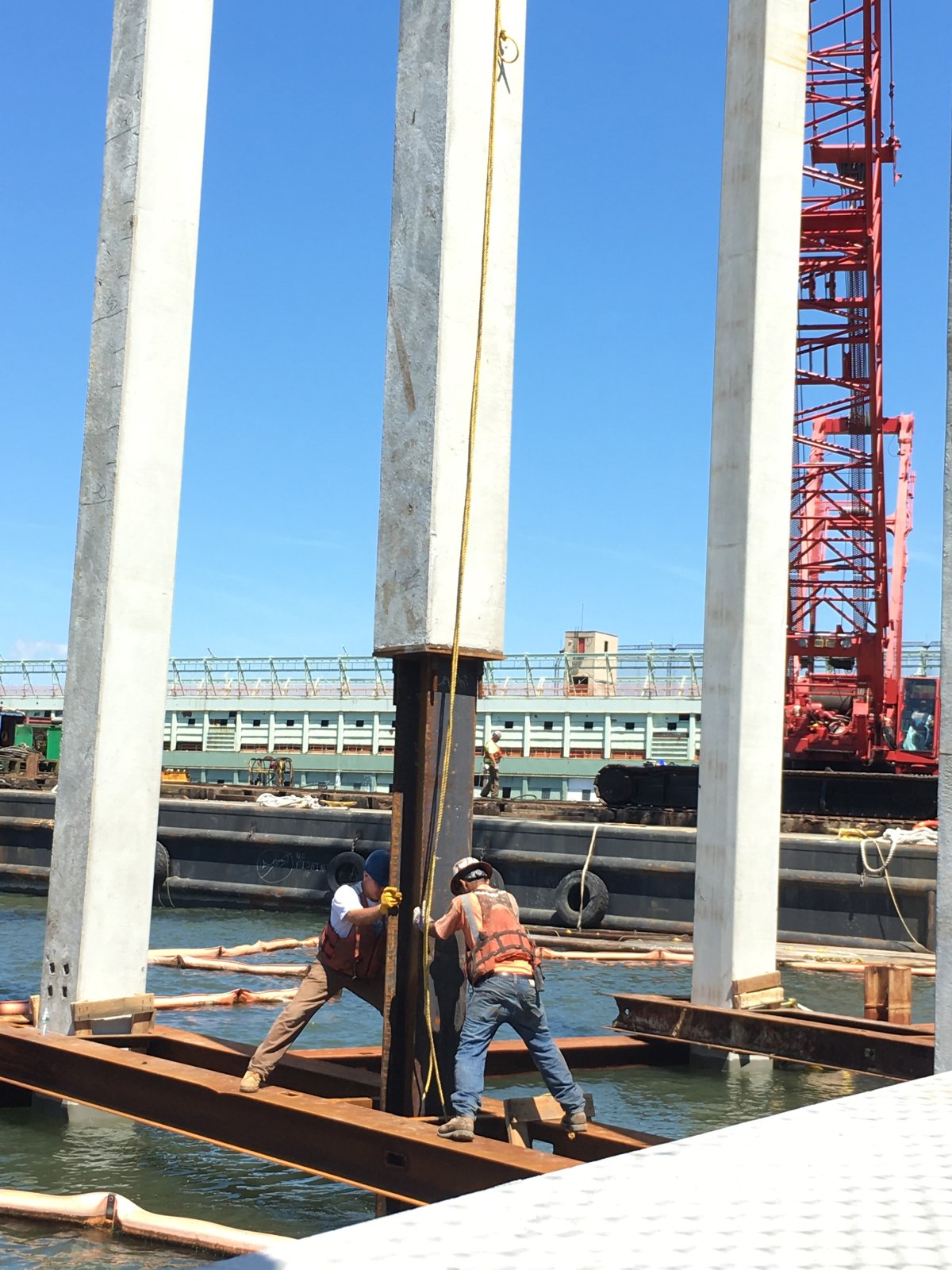 Construction workers installing more-traditional-looking piles for a part of the Pier55 project this past summer.