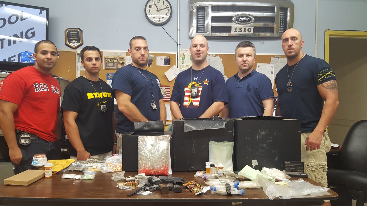 Members of the search warrant team for 258 E. Fourth St., with recovered loaded guns and drugs.  Photo courtesy N.Y.P.D.