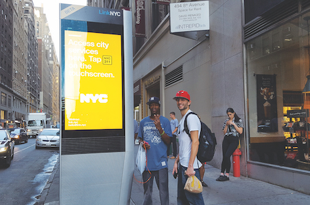 Damon Callaway and James Gambardella using an Eighth Avenue to recharge their phones. | DUSICA SUE MALESEVIC 