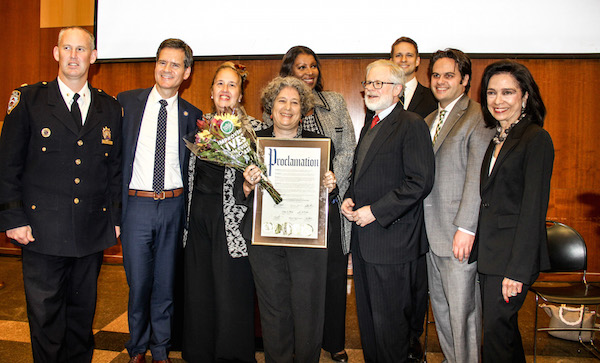 Surrounded by elected officials, NYPD leadership and FIT personnel, modest hero Jane Schreibman was compelled to step into the spotlight when presented with a Proclamation for her decisive role in preventing a second explosion on the night of Sept. 17. Photo by Tequila Minsky.