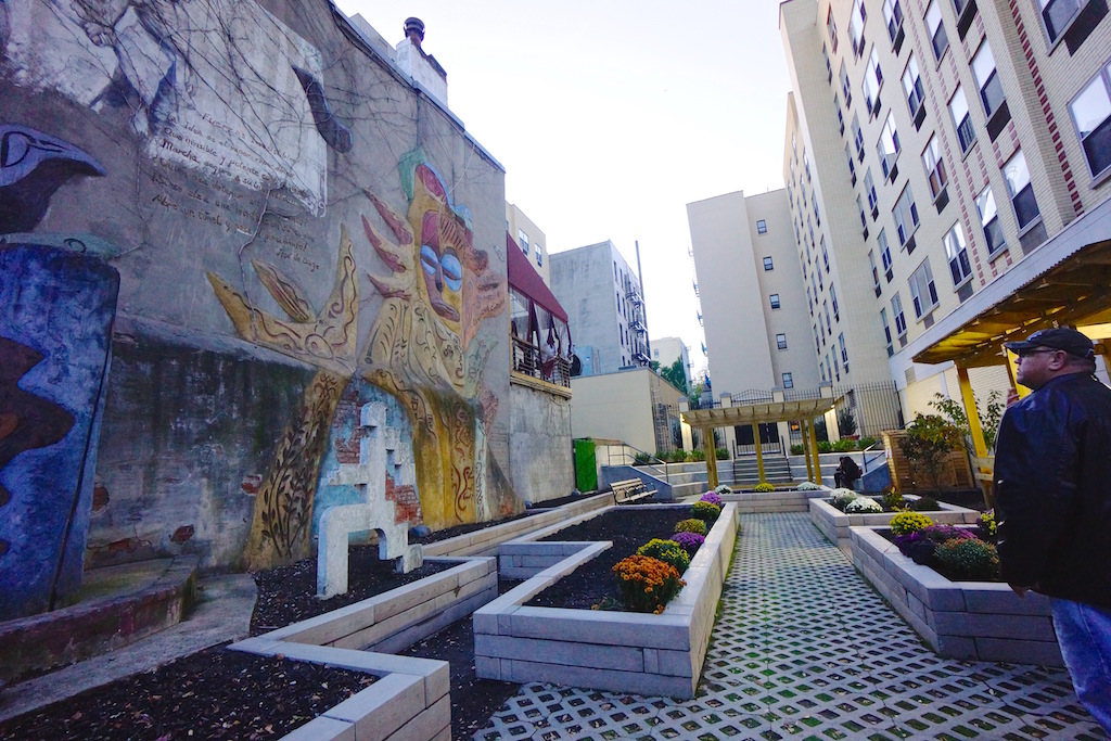 Carmen Pabon's renovated, and smaller, garden still sports its original iconic bas-relief Loisaida wall mural.